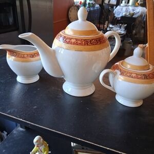 Elegant Cream and Sugar Set with Red and Gold Accents
